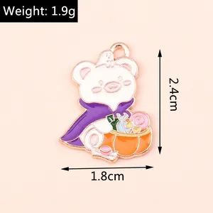Detail view of a Halloween bear enamel pendant with pumpkin basket and purple cape