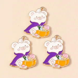 Macro view of Halloween bear enamel charms with purple cloaks and pumpkin baskets