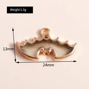 Close-up of translucent gradient bat wing pendant with gold edges and dimensions