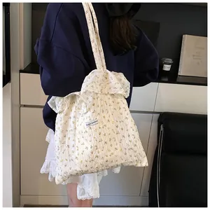 Detail of floral canvas tote bag with Magic pocket tag and pleated edge design