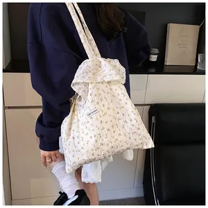 Detail of floral canvas tote bag with Magic Pocket label and ruffled cloud edges