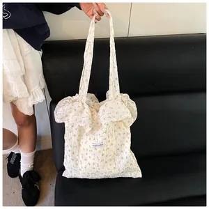 Detailed macro view of floral canvas tote with ruffles and Magic Pocket label