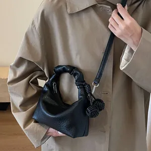 Fashionable black pleated underarm bag with lychee texture and knotted charm detail