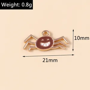 Macro shot of 10mm spider charm in brown enamel with golden legs for DIY jewelry