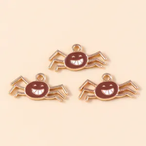 Three pieces of golden alloy spider charms with brown enamel and a cute face for DIY jewelry