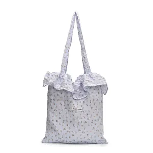 Light blue floral canvas tote bag with ruffle edge and bubble textured fabric design