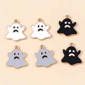 Close-up of enamel ghost charms in white, grey, and black for Halloween DIY crafts