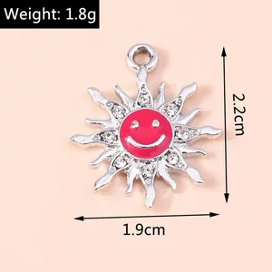 Detailed view of alloy sunflower pendant with red enamel face and sparkling rhinestones