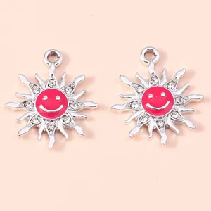 Detailed close-up of alloy sun flower pendants with pink enamel face and small crystals