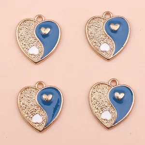 Detailed view of heart-shaped Yin Yang charms with gold alloy and blue enamel for DIY jewelry