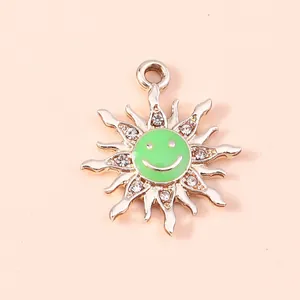 Macro detail of sun flower pendant with green enamel smiley face and sparkling crystals