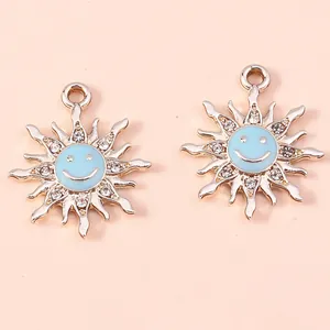 Detail of sun flower smile pendants with light blue enamel and sparkling rhinestones