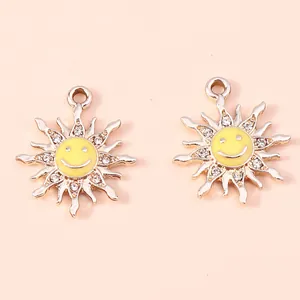 Detailed macro view of golden alloy sun flower charms with yellow smile and rhinestones