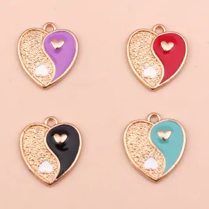 Detailed view of heart-shaped Tai Chi pendants in gold alloy for DIY jewelry crafting