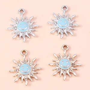 Pack of 4 silver alloy sunflower pendants with blue smiley face enamel and rhinestones