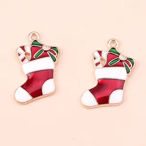 Close-up of alloy Christmas stocking pendants with red enamel and candy cane details