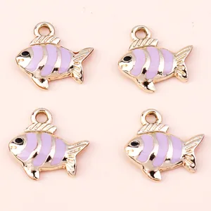 Macro view of four purple striped enamel tropical fish charms for DIY keychains