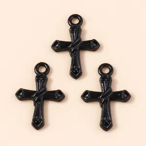 Three pieces of black cross pendants with heart-shaped ends and polished finish