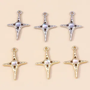 Macro shot of 6-piece star cross pendants set in gold and silver finish with moonstone center