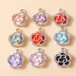 Macro view of colorful enamel rose pendants with rhinestones for DIY jewelry making