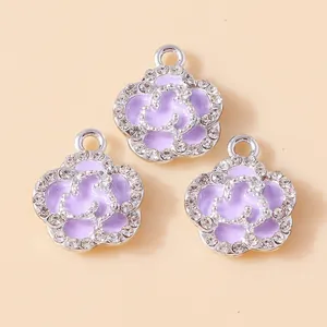 Close-up of purple enamel rose charms with sparkling rhinestones and silver metal base