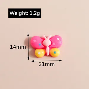 Detail view of colorful 21mm resin butterfly charm with pink and yellow gradient pattern