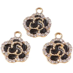Set of three black enamel rose flower pendants with gold plating and sparkling crystals