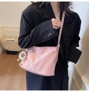 Détail du sac bandoulière rose matelassé avec accessoire de charme animal en peluche