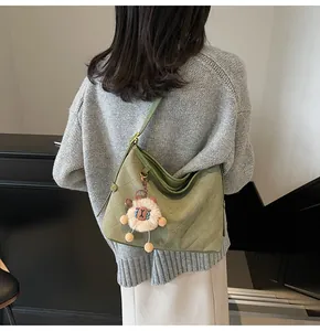 Détail du sac cabas vert matelassé avec motif losange et pendentif mouton en peluche