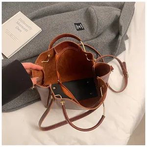 Detailed interior of a brown leather tote bag with soft lining and metal handle