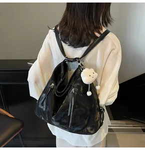 Black glossy patent leather backpack with silver zippers and a cute cloud pendant