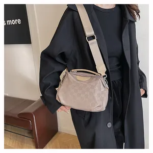 Détail du sac à bandoulière en nylon café clair avec motif monogramme et large sangle
