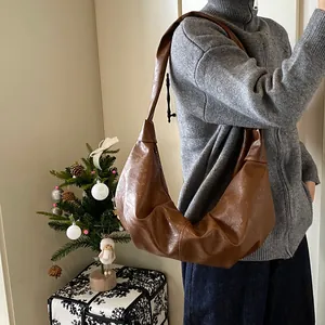 Retro soft leather hobo bag in dark brown with a slouchy crescent dumpling design