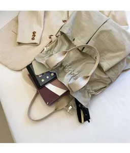 Top view of spacious interior of drawstring tote bag showing books and tablet inside