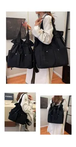 Macro view of black nylon drawstring bag showing versatile carry styles and storage pockets