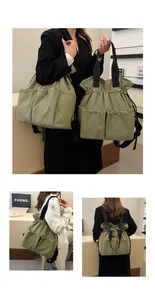 Detail showing the light green drawstring tote bag with multi-pocket and versatile straps