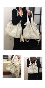 Macro view of beige nylon cloud bag showing versatile multi-pocket detail and drawstring