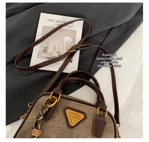 Detail of detachable and adjustable leather shoulder strap with golden metal hardware