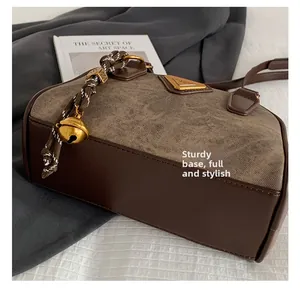 Detailed close-up of a retro brown leather bowling bag showing thick bottom and textured fabric