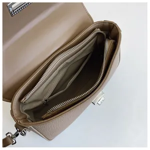 Detail view of large camel leather bag interior with zipper pockets and herringbone lining