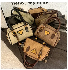 Detail view of mini bowling bags in vintage leather textures and various earthy tones