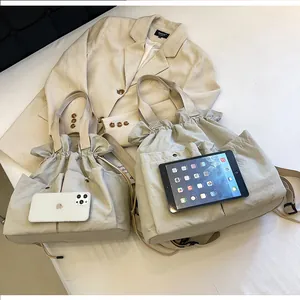 Size comparison of khaki cloud nylon bags next to a phone and tablet for scale