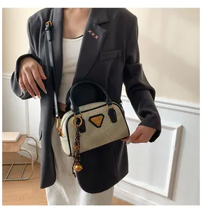 Detailed view of women's vintage Boston bag with gold hardware and decorative charms