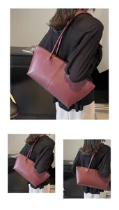 Detail view of vintage burgundy tote bag with matte leather texture and elegant stitching