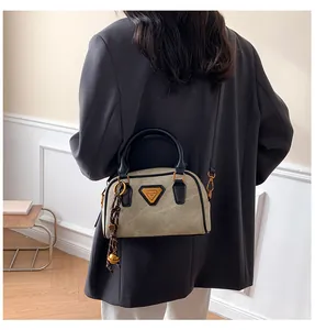 Detail of vintage beige Boston bag with black handles and contrast trim on a model