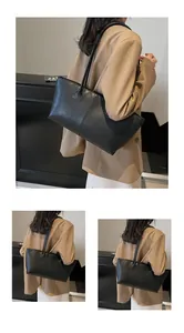 Detail shot of the black textured leather tote bag on a model in a minimalist setting