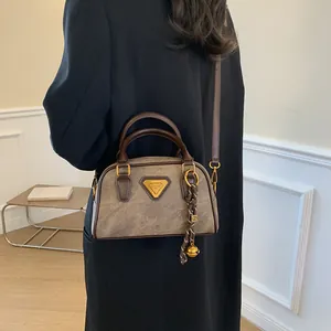 Vintage brown Boston handbag in marble textured leather with gold triangle plaque