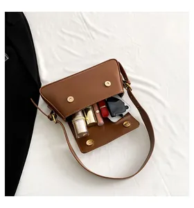 Top view of brown faux leather baguette bag showing interior storage for daily essentials