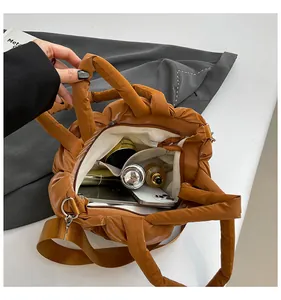 Top view of large brown puffer tote bag showing spacious interior and soft quilted texture