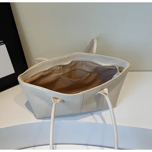 Spacious interior of beige tote bag featuring a zipper pocket and fabric lining